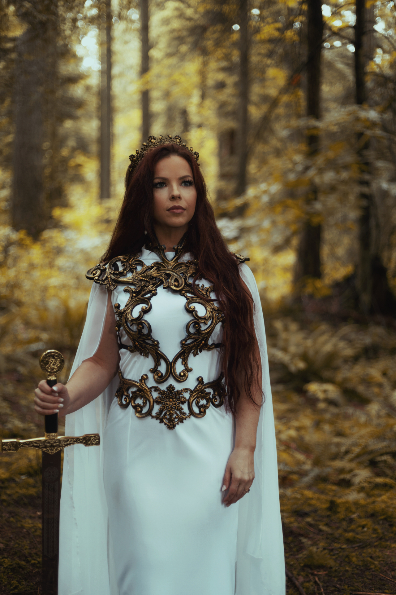 Leah McHenry in a forest, crowned and holding a sword